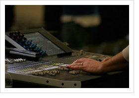 Sound-tech's hands mixing live worship on a digital mixer
