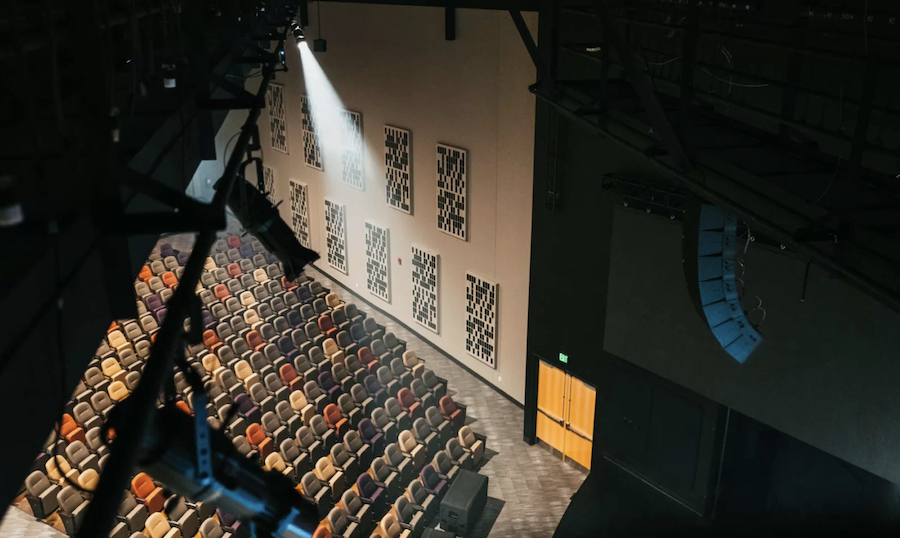 A modern church with acoustic treatment panels on the wall.