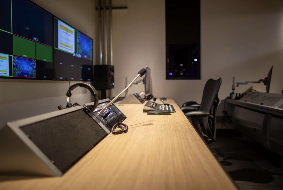 A church video production room with controllers and video monitors.