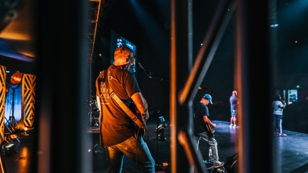 Band playing on stage with stage lighting